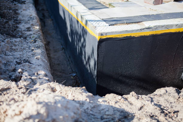Professional Basement Waterproofing technician working in Guntersville, AL